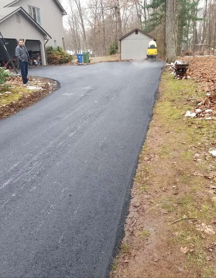 G&G Asphalt Paving crew laying fresh asphalt on a Connecticut driveway